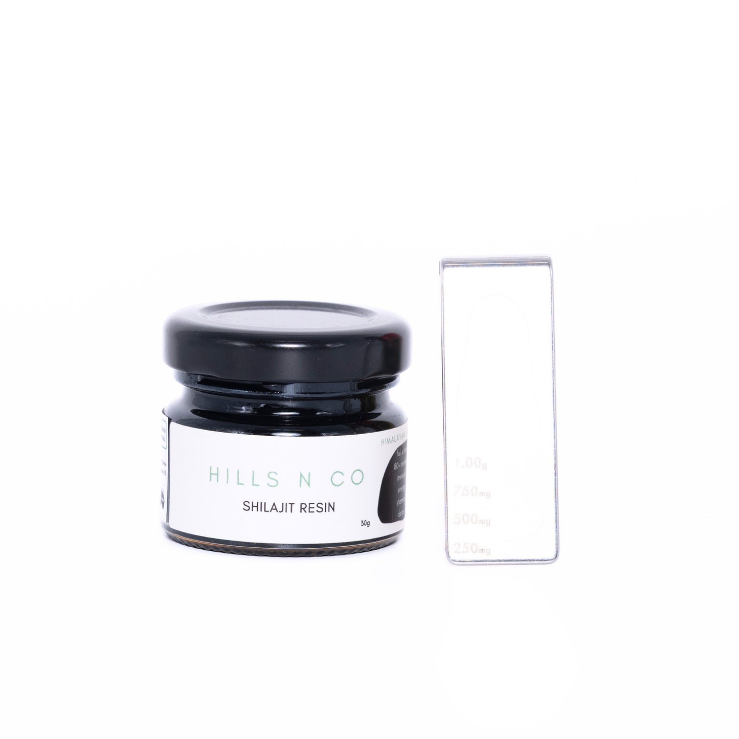 Hills N Co Pure Shilajit Resin in a glass jar with a black lid, 50g. Includes a measuring tool.